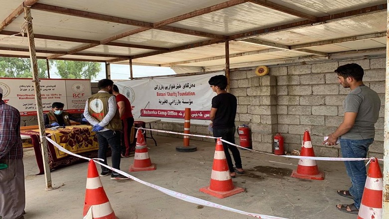 IDPs line up to register their names in order to benefit from the Iraq's Ministry of Displacement and Migration provided food parcels, June 13, 2020. (Photo: BCF)